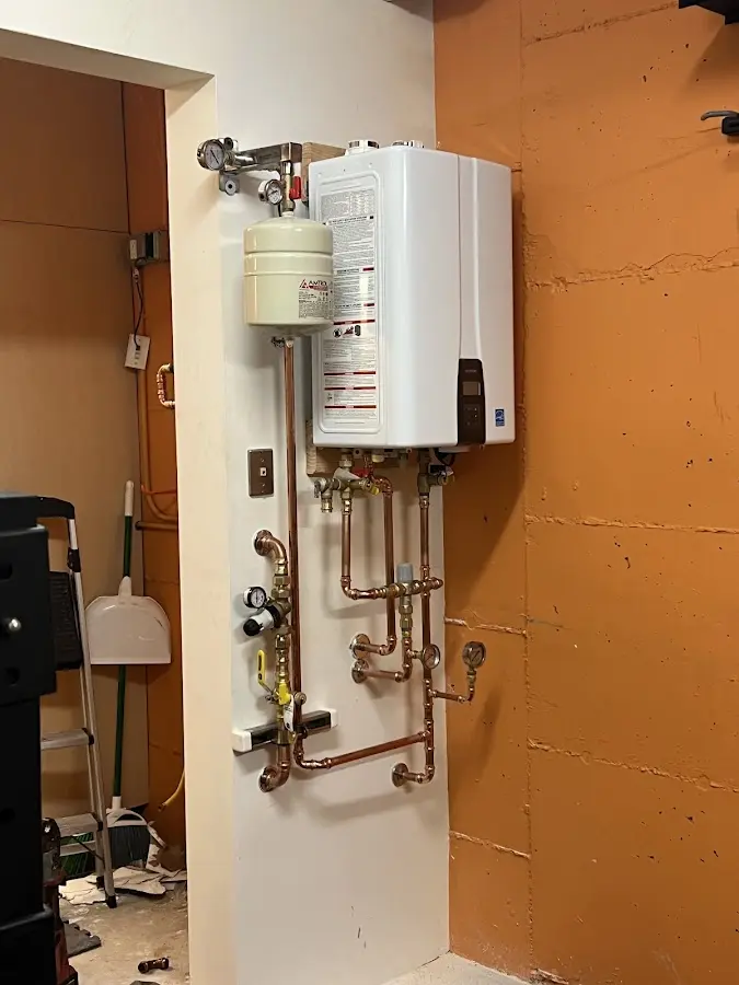 Plumbing technician inspecting water heater connections in Childress